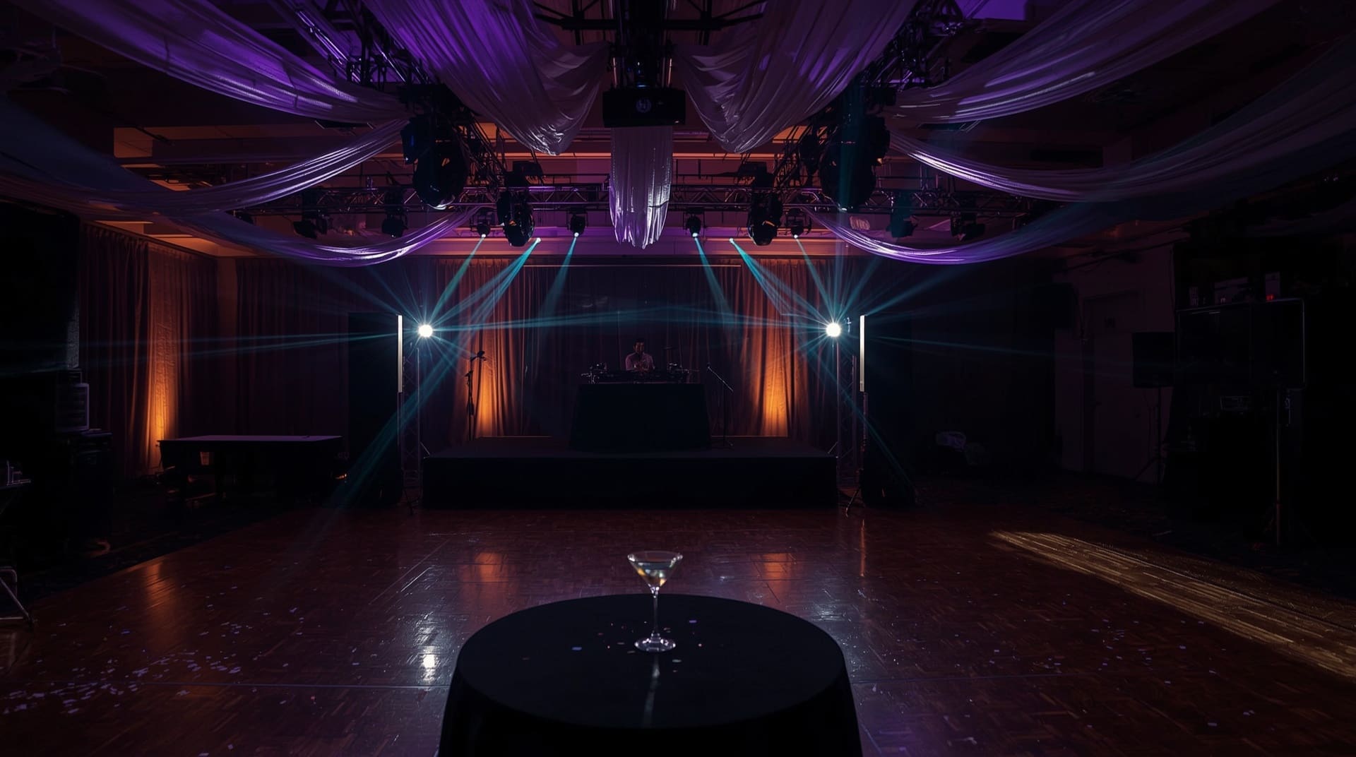 Professional DJ sound and lighting equipment filling a ballroom venue with colored beams