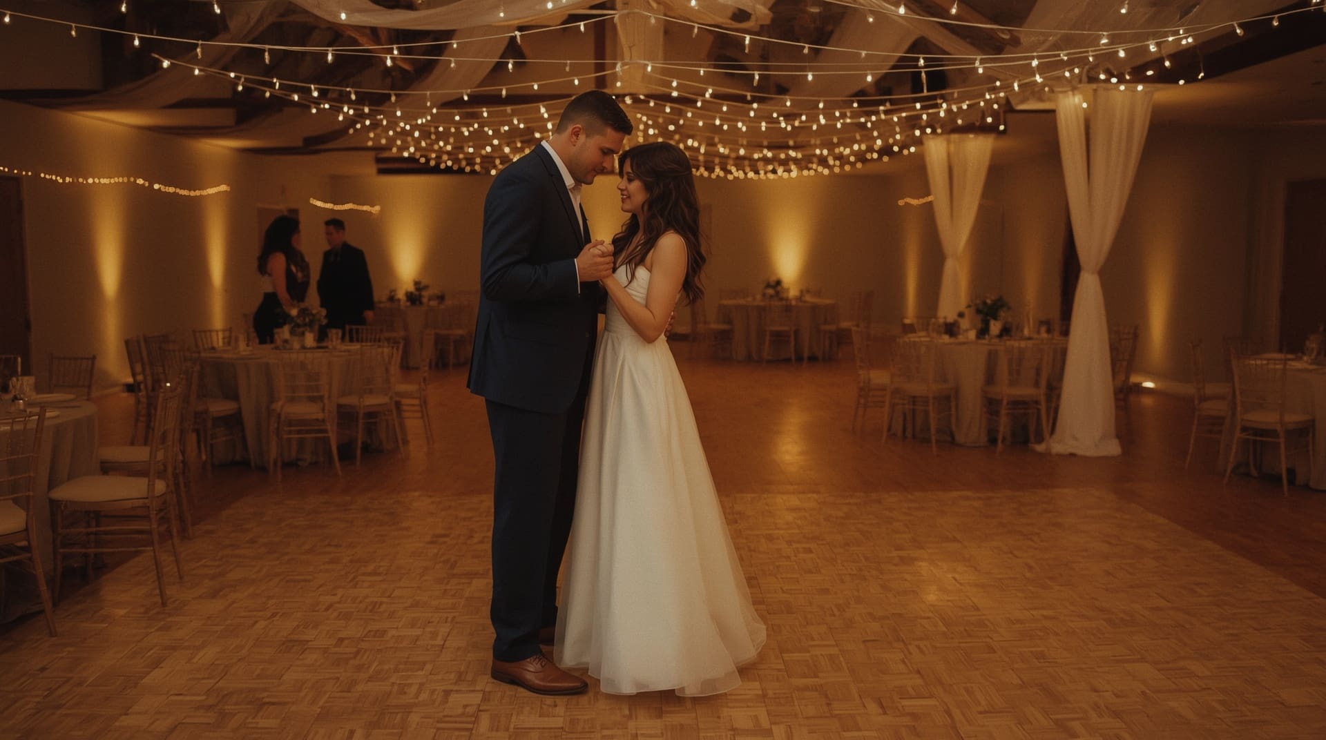 Couple sharing romantic first dance under string lights at Christian wedding reception